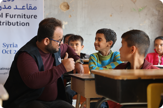 Teacher explaining lesson to children at desks